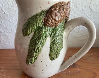 Wheel thrown and hand painted ceramic pottery stoneware mug for tea or coffee. Forest branches pinecones on tan speckles clay