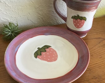 Hand painted set of 2 slip cast stoneware breakfast luncheon set mug and plate. Cute strawberry design in pink, blue and white