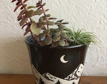 Wheel thrown and hand painted ceramic pottery flower pot or planter with drainage. Moon, trees, mountains landscape and glitter glaze.