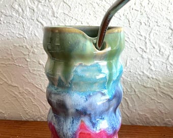 Wheel thrown and hand painted ceramic pottery stoneware drinking cup tumbler with straw. Pastel drippy rainbow color