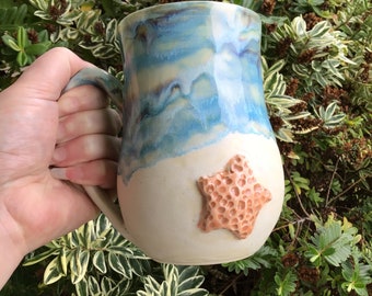 Wheel thrown and hand painted ceramic pottery mug or cup for tea or coffee. Caribbean blue ocean sea wave design with beach and starfish