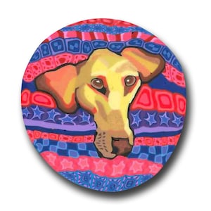 May include: A round, colorful illustration of a dog's face. The dog has tan fur and brown eyes, set against a background of blue, red, and purple patterns. The design includes stars, squares, and stripes.