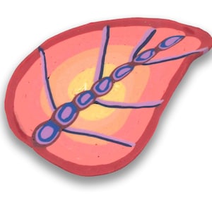 May include: A pink and orange clay leaf with a purple and blue insect design. The insect has a segmented body and long legs.
