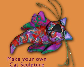 May include: A colorful cat sculpture with a patterned design in red, purple, and green. The cat has wire whiskers and a black nose. The text "Make your own Cat Sculpture" is at the bottom.