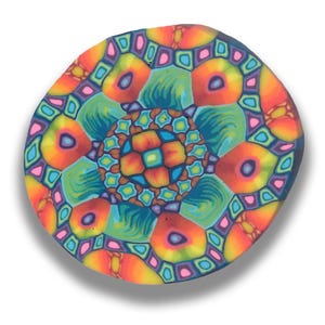 May include: A round, colorful, geometric pattern in shades of orange, pink, blue, green, and brown. The pattern is symmetrical and has a mandala-like design.
