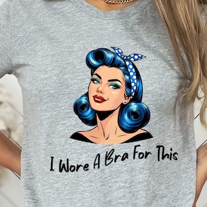 May include: A white ceramic mug with a black handle and the text "But First, Coffee" in a black, bold font. The mug is on a white surface.