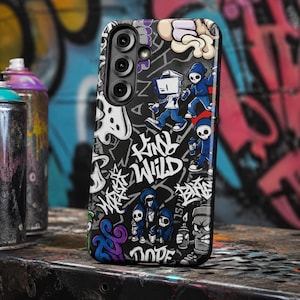 May include: A black smartphone case featuring a vibrant graffiti-style print with cartoon characters in blue hoodies, spray paint cans, and white text that reads Kind Wild and Dope, set against a dark background with various abstract street art patterns.