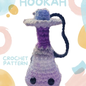 May include: A crochet pattern for a purple and blue amigurumi hookah. The pattern is a paid pattern and is available for purchase. The image includes the text "HOOKAH" and "CROCHET PATTERN".