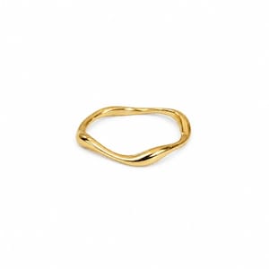 May include: A gold ring with a smooth, polished finish and a continuous, irregular wavy band design. The metal surface reflects light, highlighting the fluid, organic curves of the circular shape against a plain, neutral background.