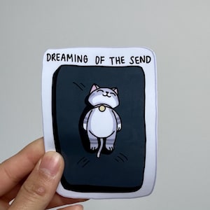Dreaming Cat on Crash Pad Autocollant en vinyle résistant à l'eau, laminé brillant, découpé avec des matrices