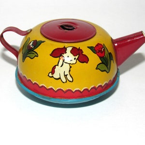 1950's Ohio Art Tin Toy Tea Pot "Boy And Girl In Garden"