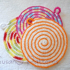 May include: Three crocheted pot holders in a spiral pattern. The top pot holder is pink, white, and blue. The middle pot holder is red, yellow, and green. The bottom pot holder is orange and white. The pot holders have a loop handle.