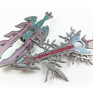 XB1 Meyneth and Zanza Monados as a Metal and Enamel Pin Necklace or Keychain