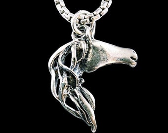 May include: A silver horse head pendant necklace with a silver chain. The pendant is detailed and has a textured finish.