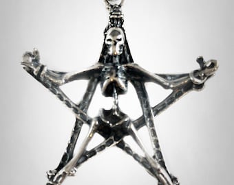 May include: A silver-toned pendant necklace featuring a skeletal figure within a five-pointed star. The pendant has a detailed, gothic design with a skull at the top and is suspended from a chain.