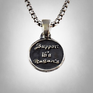 May include: Silver necklace with a round pendant that says "Support 16's Again's" in a cursive font.