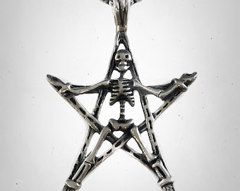 May include: A silver pendant necklace featuring a skeleton trapped inside a pentagram.