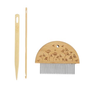 May include: Three bamboo weaving tools: a needle, a hook, and a half-circle comb. The comb has metal teeth and a floral design etched into the wood. The tools are light brown and are used for weaving.