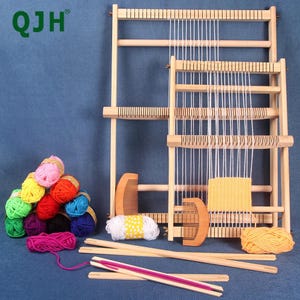 May include: A wooden weaving loom set with white yarn, colorful yarn balls, wooden combs, and weaving tools. The set includes two looms of different sizes, perfect for crafting and textile projects. The logo "QJH" is visible in the top left corner.