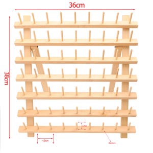 May include: A wooden thread spool holder, 36cm wide and 38cm tall, with multiple rows of pegs for organizing spools. The natural wood color and simple design make it a functional and attractive storage solution for sewing supplies.