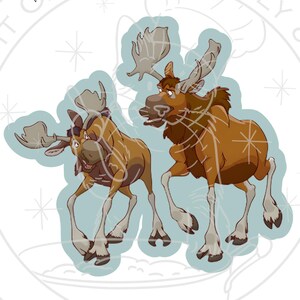 May include: Two cartoon moose illustrations in shades of brown and tan, with large antlers and expressive faces. The moose are set against a light blue background with a decorative border. Text at the top reads "ADDED BORDER FOR EASIER CUTTING!"