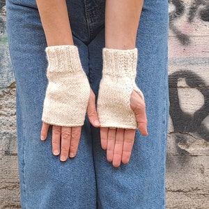 These cream fingerless gloves are hand knitted with special love and care. They are perfect for keeping you warm in cold autumn/winter days!