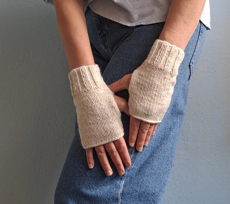 These cream fingerless gloves are hand knitted with special love and care. They are perfect for keeping you warm in cold autumn/winter days!