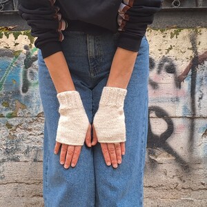 These cream fingerless gloves are hand knitted with special love and care. They are perfect for keeping you warm in cold autumn/winter days!