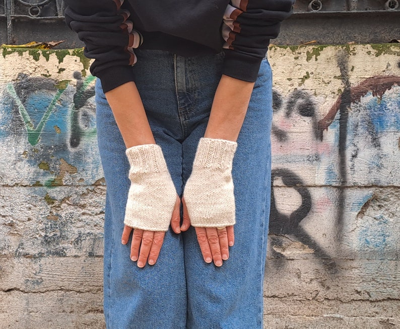 These cream fingerless gloves are hand knitted with special love and care. They are perfect for keeping you warm in cold autumn/winter days!