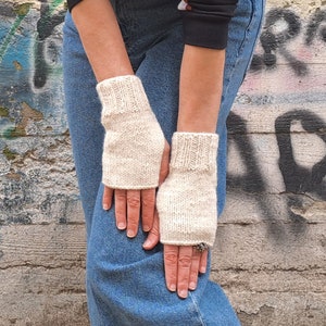 These cream fingerless gloves are hand knitted with special love and care. They are perfect for keeping you warm in cold autumn/winter days!