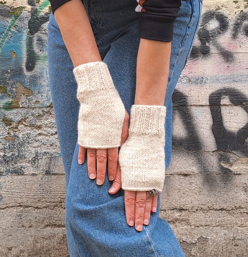 These cream fingerless gloves are hand knitted with special love and care. They are perfect for keeping you warm in cold autumn/winter days!