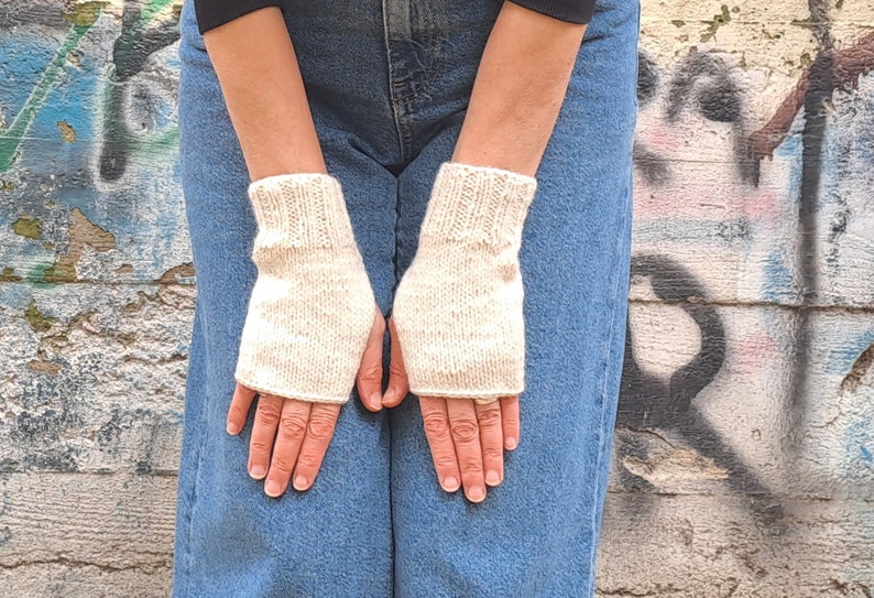 These cream fingerless gloves are hand knitted with special love and care. They are perfect for keeping you warm in cold autumn/winter days!