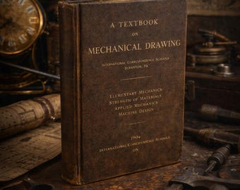 May include: A vintage textbook on mechanical drawing, with the title and subject matter in gold lettering. The book is brown and worn, with the text "International Correspondence Schools" and "Scranton, PA" visible. Other mechanical tools are in the background.