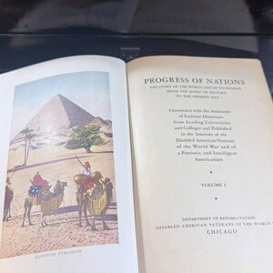 May include: An open book featuring a colour illustration of the Egyptian pyramids and camels. The text reads "Progress of Nations" and "Egyptian Pyramids". The book is Volume 1, published by the Department of Rehabilitation, Disabled American Veterans of the World, Chicago.