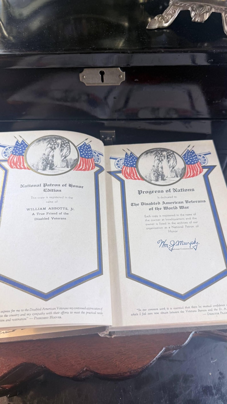 May include: An open book with two pages displayed, each with patriotic imagery and text. The left page is titled "National Patron of Honor Edition", the right "Progress of Nations". Both pages have a blue border and contain text.