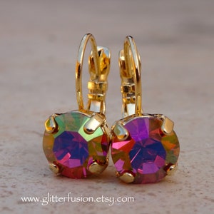 May include: Gold hoop earrings with iridescent purple and green round gemstones.