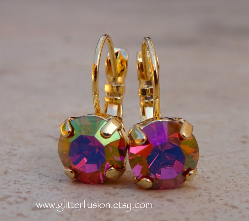 May include: Gold hoop earrings with iridescent purple and green round gemstones.