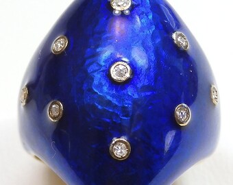 May include: A blue enamel ring with a unique, asymmetrical design. The ring is set with small, round diamonds.