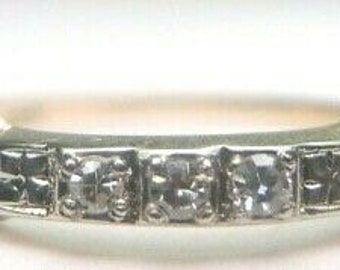 May include: A vintage gold and silver band ring with five small round diamonds set in a row.
