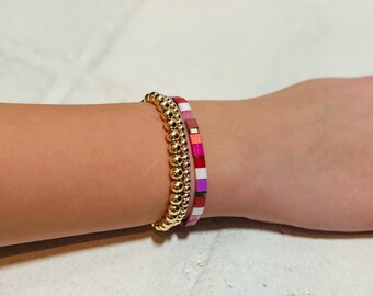 Set of three valentine tila bead and 14k gold beaded bracelets.