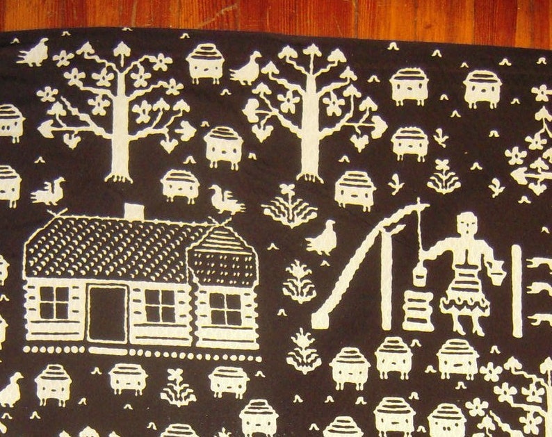 May include: A black and white textile design featuring a small house, trees, birds, and other nature-inspired motifs. The design is reminiscent of folk art and traditional patterns.