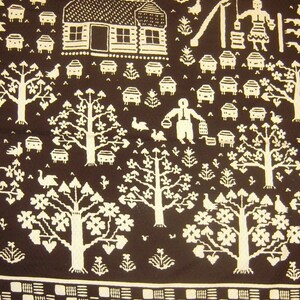 May include: A brown fabric with a white pattern of trees, houses, and other designs. The pattern is repeated throughout the fabric.