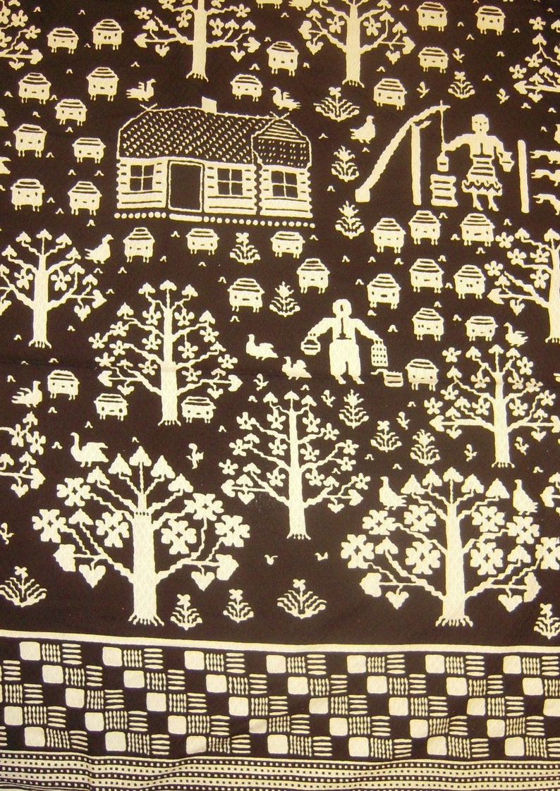 May include: A brown fabric with a white pattern of trees, houses, and other designs. The pattern is repeated throughout the fabric.