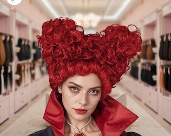 May include: A woman wearing a vibrant red wig styled in a heart-shaped design. She is dressed in a black and red outfit with a matching red pendant. The background suggests a wig shop with various hair extensions.