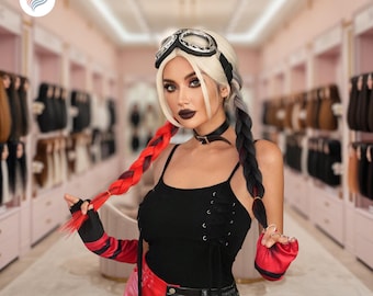 May include: A woman with a black top, red and black gloves, and red and black pants. She is wearing a wig with white, gray, red, and black braids, and goggles. The background is a pink-toned store with hair extensions.