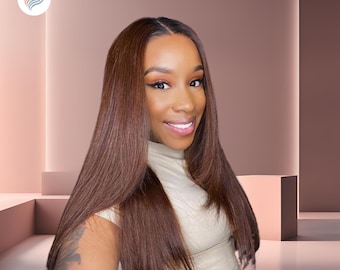 May include: A woman with long, straight, dark brown hair wearing a light beige turtleneck shirt. She is smiling and looking at the camera.