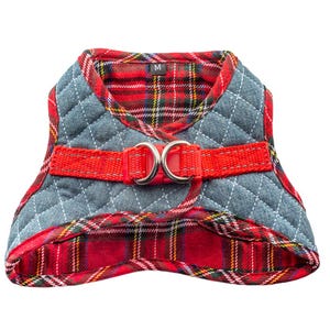 May include: Red and blue plaid dog harness with a red adjustable strap and two silver D-rings. The harness has a size label that says "M".