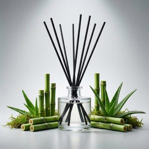May include: A clear glass diffuser bottle with black reeds, surrounded by green bamboo stalks, aloe vera leaves, and moss. The diffuser is filled with a clear liquid, creating a natural and calming aesthetic. The arrangement suggests a spa or aromatherapy theme.