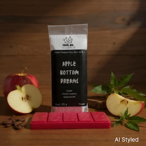May include: A red soy wax melt bar with the text "APPLE BOTTOM DREAMS" and a package that reads "EQUAL INK". The image includes a whole red apple, apple slices, and leaves. The wax melt weighs 3 oz (85 g).