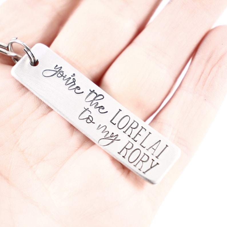 May include: Silver keychain with the text "You're the Lorelai to my Rory" engraved on it.